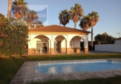 Отдельно стоящий дом с участком на продажу в городе Cartaya Фото